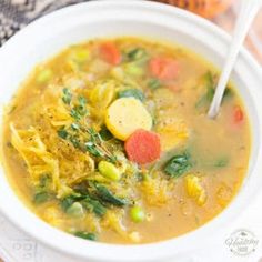 a white bowl filled with soup and vegetables