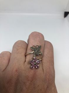 Vintage ring surrounded by Swiss cut fine Marcasite and pink ice Sterling silver Size 7 can be sized by my jeweler. His service charge is $10-$15 All rings are shipped in a nice gift box. Check out our over a THOUSAND great reviews Engraving is $4 per letter and is not always perfect depending on the piece. It can take a few days if the jeweler is busy. This is payable to Paypal Judithsltd@gmail.com Pink Sterling Silver Crystal Ring With Gem, Pink Sterling Silver Crystal Open Ring, Pink Sterling Silver Rings With Accent Stones, Pink Amethyst Ring In Sterling Silver For Anniversary, Fine Jewelry Pink Ring Stamped 925, Pink Fine Jewelry Ring Stamped 925, Pink Sterling Silver Open Ring Jewelry, Pink Amethyst Ring In Sterling Silver As Gift, Pink Sterling Silver Flower Ring As Gift