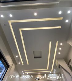 the ceiling in this room is decorated with white lights and recessed lighting above it