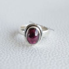 Gemstone-Garnet Shape-Oval Metal-925 Sterling Silver This One of a kind ring is adorned with beautiful Garnet Gemstone set in sterling silver. About gemstones-Garnet is intense red colour stone resembling the glistening, deep red seeds of the fruit. This red stone is associated with true friendship, devotion,loyalty, self esteem, success and passion. Garnet protects from negativity and warn off evil spirits and leads way to spiritual world.Wearing Garnet stone promotes good health and enhances b Oval Garnet Rings, Oval Cabochon Ruby Ring Gift, Oval Cabochon Garnet Rings For Anniversary, Oval Cabochon Ruby Ring In Sterling Silver, Handmade Oval Ruby Ring For Anniversary, Sterling Silver Oval Cabochon Ruby Ring Gift, Silver Ruby Ring With Oval Cabochon, Handmade Oval Garnet Rings, Handmade Oval Cabochon Ruby Ring For Anniversary