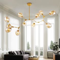 a living room filled with furniture and lots of windows