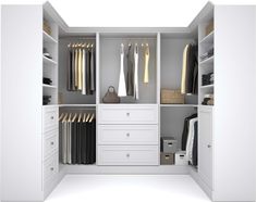 an open white closet with clothes and other items