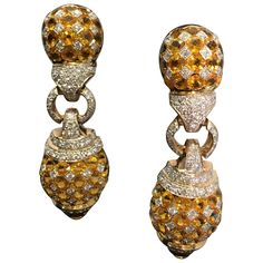 Magnificent 18 karat yellow gold "door knocker" dangle style omega lever back earrings for pierced ears have 3 segments hinged together for maximum sparkle through movement. The top and bottom segments feature a harlequin pattern of rose cut yellow sapphires and round brilliant diamonds. The yellow sapphires are tension set with gold squares set on a diagonal, each of which contain a pave set round diamond. The center segments, the bottom of the top segments, and the top of the bottom segments a Door Knocker Earrings, Gold Door, Sparkly Jewelry, Family Jewels, Door Knocker, Antique Diamond, Antique Earrings, Sapphire Jewelry, Yellow Sapphire