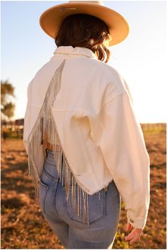 This adorable "Rhinestone Fringe Denim Jacket" is the perfect statement piece for any country concert, western event, or everyday affair! This jacket is true to size with a cropped length in the front, two pockets in the front, and it features an overlap of diamond fringe with an opening on the back. You can wear this buttoned as a top or unbuttoned as a jacket. Throw this on with some booties and pair it with any form-fitting top and some flairs or a skort for a fun look! Product details: -Hand Edgy Concert Outfit, Edgy Outfits Grunge, Western Event, Concert Outfit Plus Size, Rap Concert Outfit, Fringe Denim Jacket, Concert Outfit Rock, Cute Edgy Outfits, Classy Edgy