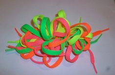 a bunch of colorful hair clips on a white surface