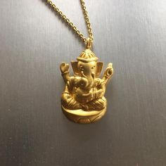 This adorable 18kt gold plated 'Ganesh' pendant hung beautifully is your everyday jewelry. It is believed that wearing Ganesh jewelry is like wearing any talisman such as an evil eye or hamsa. Ganesh (also spelled Ganesa or Ganesha and known as Ganapati, Vinayaka, and Pillaiyar) is the Lord of Good Fortune who provides prosperity, fortune, and success in Hinduism. He is the 'Lord of Beginnings' and the 'Remover of Obstacles' of both material and spiritual kinds. Carrying the same spiritual/relig Ganesha Jewelry Gold, Ganesh Ji Pendant Gold, Ganesh Ji Pendant, Ganesh Locket Pendants, Gold Thumb Rings, Ganesha Elephant, Ganesh Pendant, Ganesha Pendant, Gold Chain Design