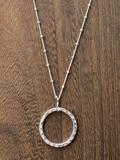 Gorgeous large sterling hammered hoop is the focal of this necklace, embellished with faceted satellite ball sterling chain, and a sterling clasp and components. 18.5 inches long. Perfect for any occasion, but certainly a show stopper for holiday parties! Everyday Sterling Silver Hoop Necklaces, Silver Circle Necklace Nickel Free, Silver Hammered Full Circle Jewelry, Silver Full Circle Hammered Jewelry, Hammered Silver Full Circle Jewelry, Silver Satellite Chain Necklace With Round Pendant, Everyday Silver Hoop Necklaces, Silver Necklace With Satellite Chain, Silver Open Circle Hammered Jewelry