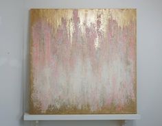 a painting is hanging on the wall in a room with white and gold paint,