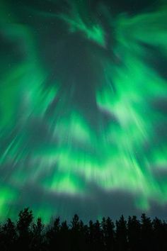 an aurora bore is seen in the night sky