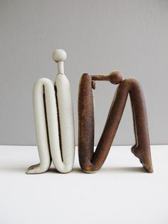 a couple of wooden objects sitting on top of a white table next to each other