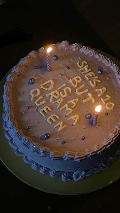 a birthday cake with two candles on it