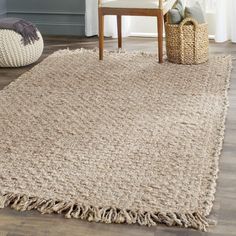 a rug with fringes on the floor in a living room