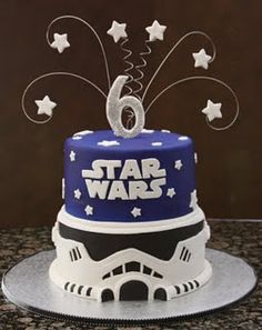 a star wars themed birthday cake with the number six on top and stars in the background