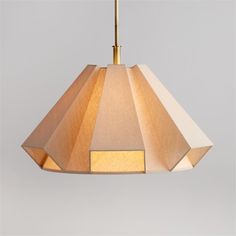 a lamp hanging from a ceiling with a beige shade on it's top and bottom