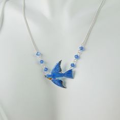 A vision in brilliant blue enamel with cobalt Swarovski stones on each side, this cloisonné and sterling silver Bluebird necklace is certain to charm and impress. The Bird hangs from a sterling chain that can be adjusted from 16 inches to 20 inches that culminates in another Swarovski bead at the end that dangles deliciously down your back when worn shorter. The Bird itself is 7/8 inch wide from beak to tail and has a wingspan of just over .75 inch. The necklace is in excellent, new condition and is marked 925 on the back. So very suitable for gift-giving, they'll certainly know you care! Blue Enamel Necklaces With Lobster Clasp, Crystals Blue, Swarovski Beads, Swarovski Stones, Bird Jewelry, Bird Design, Austrian Crystal, Jewelry Bags, Blue Bird