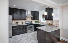 a kitchen with granite counter tops and black cabinets