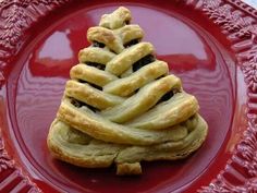 a pastry shaped like a christmas tree on a red plate