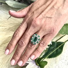 This One-of-a-Kind, Custom-Made Natural Emerald and Diamond Ring is a luxurious piece designed to captivate. Crafted in 14k gold, it showcases a finely faceted, high-quality natural emerald as the center stone, radiating deep green elegance and sophistication. The emerald is complemented by a stunning arrangement of brilliant diamonds that enhance its color and sparkle. Sized at 6.5 and resizable for a perfect fit, the ring has an impressive total carat weight (TCW) of 4.52 carats. Certified and Oval Multi-stone Emerald Ring In Platinum, Luxury Multi-stone Emerald Platinum Ring, Gia Certified Elegant Emerald Gemstones, Elegant Gia Certified Emerald Gemstones, Green Cluster Luxury Ring, Gia Certified Emerald Cut Gemstones For Anniversary, Luxury Multi-stone Emerald Ring With Diamonds, Elegant Green Gia Certified Gemstones, Luxury Green Cluster Ring With Round Cut