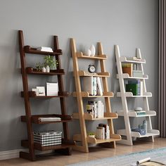 three bookshelves are lined up against the wall in this living room, one is empty