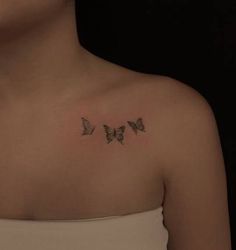 a woman with three butterflies on her chest