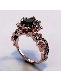 a rose shaped ring with black diamonds on it