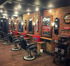 a barber shop with several chairs and lights