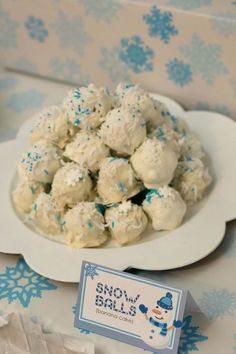 snow balls on a white plate with blue sprinkles and a small business card