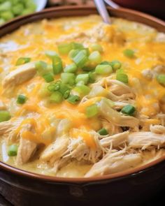 a bowl filled with chicken and green onions