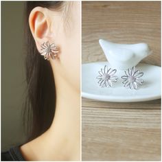 Silver flower stud invisible resin clip on earrings, metal is Rhodium plated over brass. Details :- **Earrings length is 20mm, width is 20mm. **Approx weight is 2.25g (4.5g per pair) ♥ ♥ Invisible resin clip on are soft and elastic, so it is comfortable to wear and will not drop off easily. Since they are invisible so they look like pierced ear earrings. But they are fragile, so pls handle these earrings with care and don't spread too wide. ♥ ♥ These earrings will be packed into a Gift box. ♥ ♥ White Minimalist Single Clip-on Earring, Silver Minimalist Hypoallergenic Clip-on Earrings, Minimalist Adjustable Silver Clip-on Earrings, Silver Flower Clip-on Earrings In Sterling Silver, Elegant Sterling Silver Flower Clip-on Earrings, Ear Earrings, Pearl Gemstone, Flower Studs, Silver Flowers