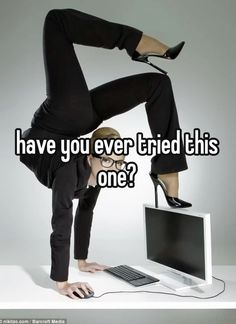 a woman standing on top of a computer desk with her legs up in the air