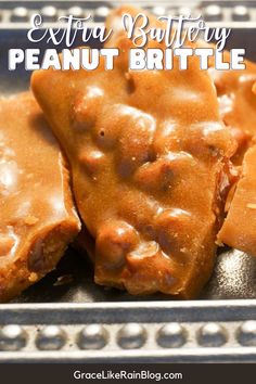 some kind of food that is on a metal tray with the words extra buttery peanut brittle