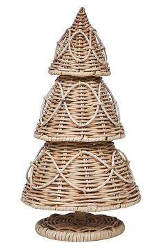 a wicker christmas tree sitting on top of a table