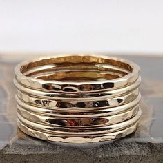 This Hammered & Polished Gold-filled stacking ring set is entirely hand-made & mixes well with most of the items in our store. * This listing is for one 7-band set. You will receive: * Four 16g Hammered Gold-filled rings * Three 16g Polished Gold-filled rings * When stacked, they measure at about 7 rings per half inch. * We do make 1/2 & 1/4 sizes, just leave a note with your size preference. * All of our items are entirely hand crafted and have a standard processing time of 3-5 Business days to Stackable Adjustable Rings With Thick Band, Stacked Ring Jewelry Gift, Classic Handmade Gold Stackable Rings, Adjustable Thick Band Stackable Rings, Stacked Rings In 14k Gold As Gift, Stacked 14k Gold Rings For Gift, Stacked 14k Gold Rings As Gift, Stacked Wedding Rings Jewelry, Handmade Jewelry With Thick Band For Everyday