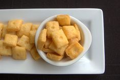 a white plate topped with cut up cubes of food