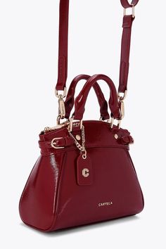 This Carvela Mini Valentina Tote bag features a wine red exterior in a trapeze style. There are two buckled straps across each side of the bag and branded gold tone hardware across the bag. Dimensions: 19cm (H), 22cm (L), 10cm (D). Strap length: 111cm. Trending Boots, Bags Purses, Sunglasses Sale, Boots For Sale, Jeans For Sale, Skirts For Sale, Wine Red, Shoe Sale, Handbag Accessories