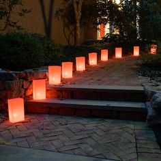 many lit candles are on the steps outside