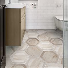 a bathroom with hexagonal tile flooring and white walls