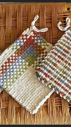 two pieces of woven material sitting on top of a wicker tablecloth next to each other