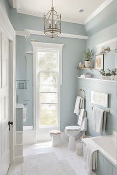 a bathroom with blue walls and white trim on the ceiling, along with a bathtub