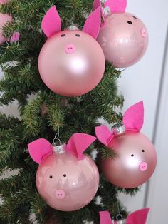 pink pig ornaments hanging from a christmas tree