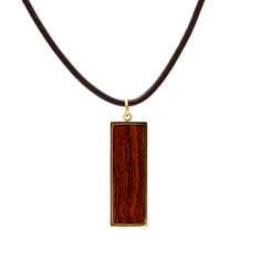 Hawaiian Koa Wood Rectangle Pendant Experience the beauty and uniqueness of Hawaiian culture with this Koa wood pendant. Handcrafted from Koa wood, each piece features a one-of-a-kind wood grain framed in three stylish colors, silver-plated, gold-plated, or rose gold-plated steel bezel. The leather cord necklace adds a touch of modernity to this Hawaii treasure inspired by the strength and bravery of Polynesian warriors. Embrace the rich traditions of Hawaiian wooden jewelry with this elegant an Rectangular Brown Jewelry As A Gift, Rectangular Brown Jewelry Gift, Rectangular Brown Jewelry For Gifts, Brown Rectangular Jewelry Gift, Minimalist Brown Rectangular Jewelry, Brown Rectangular Pendant Necklace As Gift, Elegant Natural Wood Jewelry For Gift, Rectangular Brown Engraved Jewelry, Brown Rectangular Engraved Jewelry