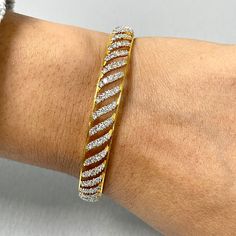 The Curves Bangles Set is inspired and created to reflect Indian tradition and design. With diamonds studded in a yellow gold, these bangles exude an ethereal glow. Total Diamond Weight: 7.70 ct No. of Diamonds: 400Diamond Color: G - HDiamond Clarity: VS Metal: 18K Yellow GoldMetal Wt: 34.46 gms Setting: Prong Set Inner Diameter: 2.4 Inches (6.10 cm) Wedding Bangle In Yellow Gold With Brilliant Cut, Wedding Brilliant Cut Yellow Gold Bangle, Wedding Yellow Gold Bangle With Brilliant Cut, Dazzling Diamond Bangle Bracelet With Pave Setting, Yellow Gold Diamond Bangle Bracelet With Sparkling Stones, Formal Gold Bangle With Single Cut Diamonds, Yellow Gold Diamond Bangle With Sparkling Stones, Yellow Gold Diamond Bracelet With Sparkling Stones, Gold Diamond Cut Dazzling Bracelet