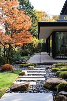 a japanese garden with stepping stones and trees in the background, along with gravel walkways