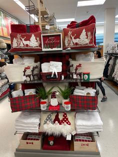 a christmas display in a store with red and white items on the shelves for sale