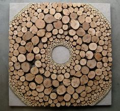 there is a circular design made out of wood logs on the floor and in the center