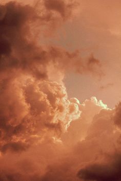 an airplane is flying in the sky with clouds