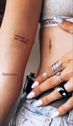 two women with tattoos on their arms and one has a quote tattooed on her arm