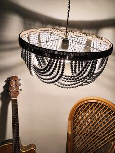 a chandelier hanging from the ceiling next to a guitar