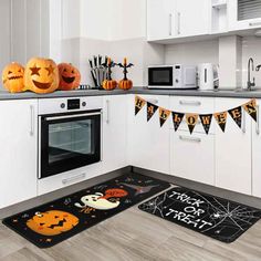 a kitchen decorated for halloween with pumpkins and jack - o'- lantern decorations