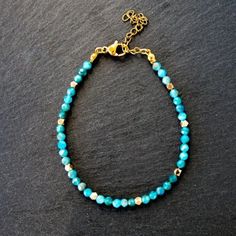 Beautiful Teal Blue Natural Apatite Beaded Bracelet. Genuine Gemstone Beads 2mm With Gold Plated Beads Spaced Throughout. Chain Is 18k Pvd On Stainless Steel Bracelet Measures 6.5" With 1" Extender Looks Pretty Stacked With A Gold Chain. See My Gold Chains In My Shop To Bundle And Save! Tags - Gift For Aunt Sister Gift For Girlfriend Wife Gift For Mother Gift Grandmother Bridesmaid Gift Stocking Stuffer Birthstone Vacation Jewelry Resort Wear Versatile Necklace Turquoise Whimsical Jewelry Elegan Blue Gemstone Beads Rondelle Beaded Bracelets, Blue Rondelle Gemstone Beaded Bracelets, Apatite Beaded Bracelets As Gift, Dainty Blue Beaded Bracelets With Faceted Beads, Adjustable Apatite Beaded Bracelets, Blue Crystal Bracelet With Tiny Beads, Vacation Jewelry, Gift For Aunt, Chevron Bracelet